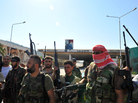 Syrian rebels pose after seizing control of the Bab al-Hawa border post on the Syrian-Turkey border on July 20. Now, the rebels are facing a new challenge: radical Islamists, who they say do not represent them. Syrian rebels pose after seizing control of the Bab al-Hawa border post on the Syrian-Turkey border on July 20. Now, the rebels are facing a new challenge: radical Islamists, who they say do not represent them.